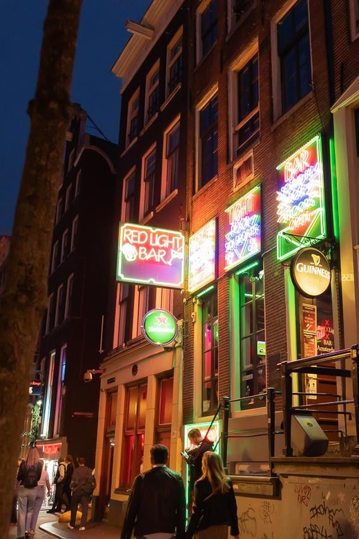 Amsterdam: Red Light Tour Exclusive + Peep Show - Dam Square and the Condomerie: setting the scene