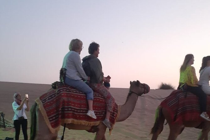 Dubai Desert Safari with Quad Bike, Camel Ride, Dinner and Shows - Belly dance, Tanura, and fire performances