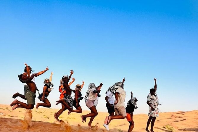 Dubai Evening Desert Safari w/ Barbeque Dinner, Camel Ride & Show - Sandboarding and the high-dune sunset
