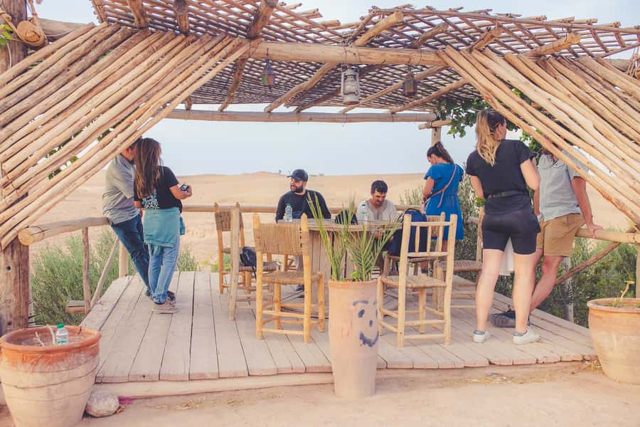 From Marrakech: Agafay Desert Camel Ride and Dinner and Show - Mounting the camel in Agafay