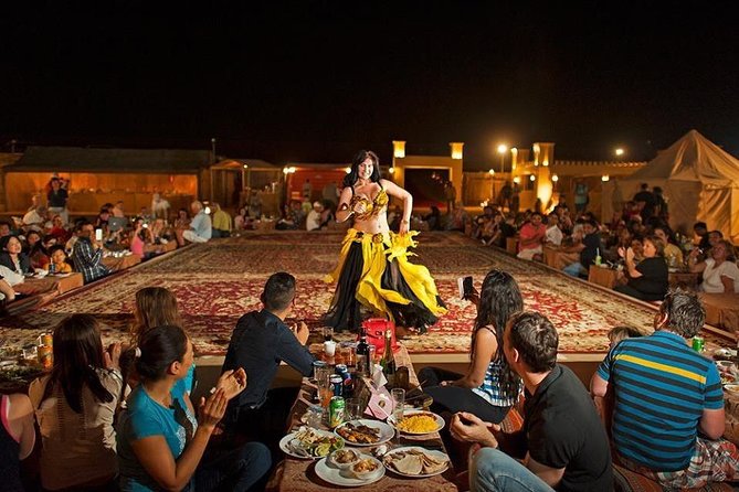 Red Dune Desert Safari with BBQ Dinner, Sand Boarding Dance Shows - Dinner on carpets, pillows, and a busy stage