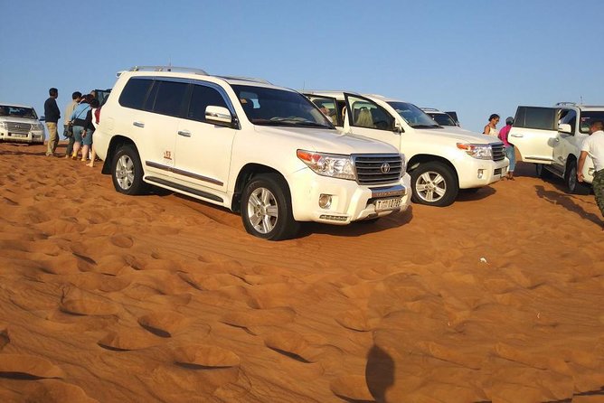 Red Dunes Dubai Desert Safari with Live show, Sandboarding & BBQ - Red dunes, sharp turns, and a sunset stop